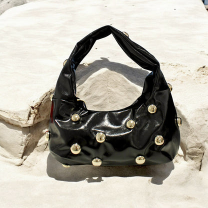 BOLSO DE MANO TACHAS